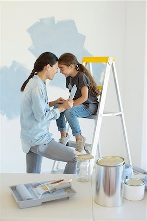 paint children - Mother and daughter painting wall blue Stock Photo - Premium Royalty-Free, Code: 6113-07147151