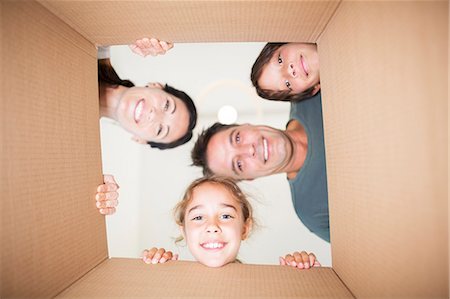 family hispanic father mother children boy girl - Family looking down at camera through cardboard box Stock Photo - Premium Royalty-Free, Code: 6113-07147167