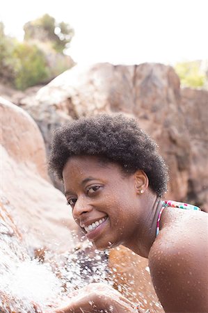 simsearch:6113-07147524,k - Portrait of smiling woman at waterfall Stock Photo - Premium Royalty-Free, Code: 6113-07147101