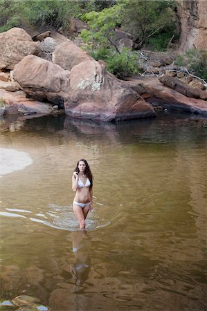 simsearch:6113-07158879,k - Woman wading in pool Stockbilder - Premium RF Lizenzfrei, Bildnummer: 6113-07147109