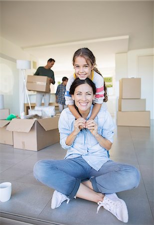 Portrait of smiling mother and daughter among cardboard boxes Photographie de stock - Premium Libres de Droits, Code: 6113-07147138