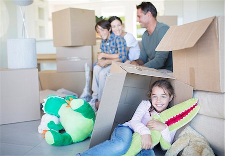 ethnic diverse boy and girl playing - Family among cardboard boxes in livingroom Stock Photo - Premium Royalty-Free, Code: 6113-07147242