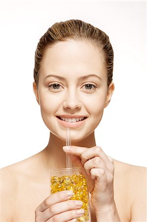 Woman drinking glass of vitamins Stock Photo - Premium Royalty-Free, Code: 6113-07147263