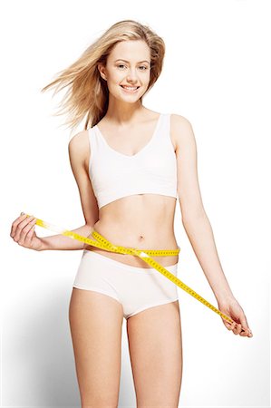 diet happy - Woman measuring her waist Stock Photo - Premium Royalty-Free, Code: 6113-07147261