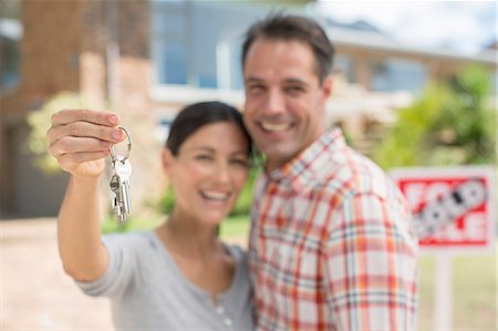 people, house exterior - Portrait of smiling couple holding house keys Stock Photo - Premium Royalty-Free, Code: 6113-07147221