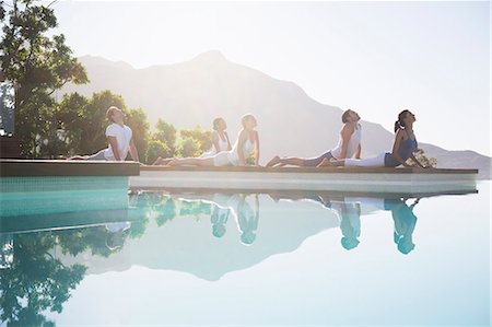 sun flare energy - People practicing yoga at poolside Stock Photo - Premium Royalty-Free, Code: 6113-07147437