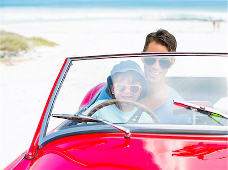 sea father son caucasian two - Father and son driving convertible on beach Stock Photo - Premium Royalty-Free, Code: 6113-07147693