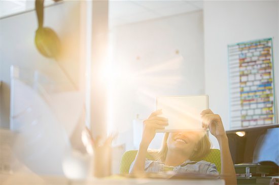 Businesswoman using digital tablet in office Stock Photo - Premium Royalty-Free, Image code: 6113-07147844