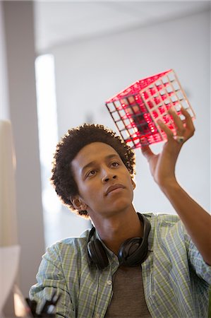 person study - Businessman examining cube in office Stock Photo - Premium Royalty-Free, Code: 6113-07147851