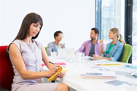 simsearch:6113-07731472,k - Businesswoman taking notes in meeting Stock Photo - Premium Royalty-Free, Code: 6113-07147987