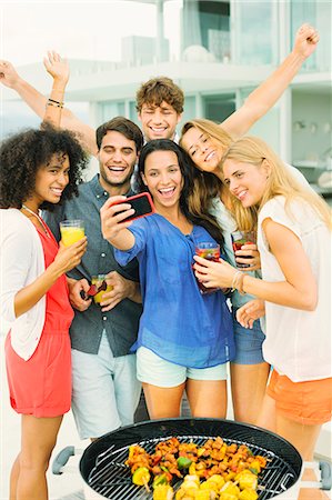 energy party - Friends taking self-portrait with camera phone at barbecue Stock Photo - Premium Royalty-Free, Code: 6113-07147999