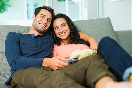 Couple watching television on sofa Stock Photo - Premium Royalty-Free, Code: 6113-07148055