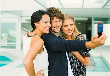 pool side - Friends taking self-portrait at poolside Stock Photo - Premium Royalty-Free, Code: 6113-07148067