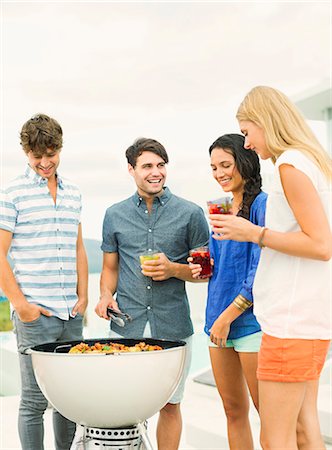 Friends talking around barbecue Stock Photo - Premium Royalty-Free, Code: 6113-07148017