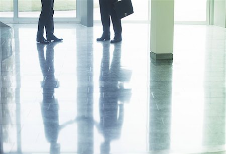 simsearch:6113-06498829,k - Reflection of businessmen shaking hands in office lobby Stock Photo - Premium Royalty-Free, Code: 6113-07158946