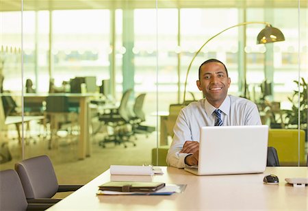 simsearch:693-06379459,k - Businessman smiling at desk Stock Photo - Premium Royalty-Free, Code: 6113-07158961