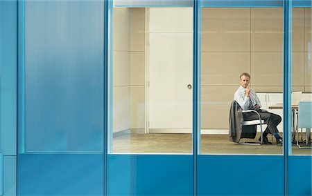 Businessman sitting in conference room Stock Photo - Premium Royalty-Free, Code: 6113-07158900