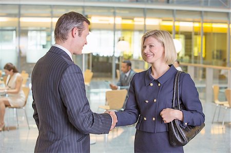 simsearch:614-08148387,k - Business people shaking hands in office Fotografie stock - Premium Royalty-Free, Codice: 6113-07158901