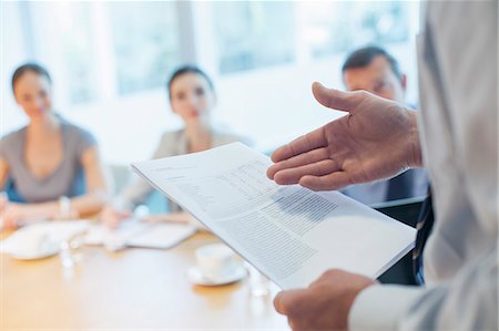 paperwork in hand - Businessman leading meeting in conference room Stock Photo - Premium Royalty-Free, Code: 6113-07158938