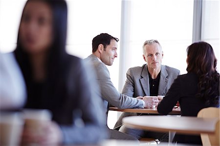 Business people talking in cafe Stock Photo - Premium Royalty-Free, Code: 6113-07159072