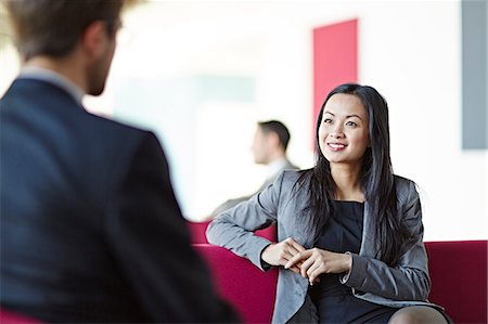 Business people talking in office lobby Stock Photo - Premium Royalty-Free, Code: 6113-07159114