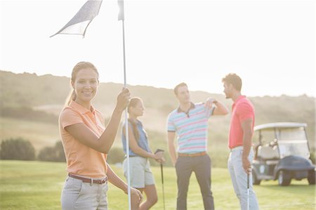 simsearch:6113-07159250,k - Smiling friends on golf course Stock Photo - Premium Royalty-Free, Code: 6113-07159273