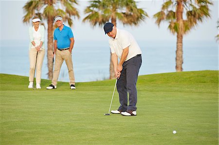 simsearch:6113-07159269,k - Senior friends playing golf on course Stock Photo - Premium Royalty-Free, Code: 6113-07159222
