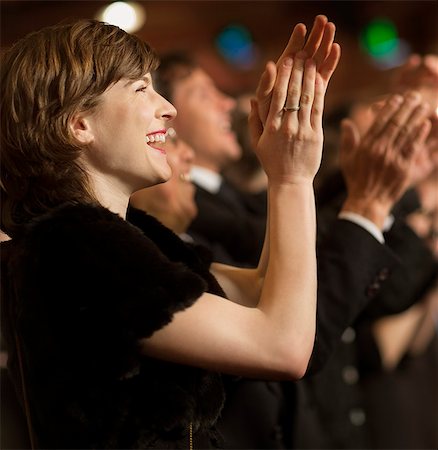 simsearch:6113-07160115,k - Happy woman clapping in theater audience Stock Photo - Premium Royalty-Free, Code: 6113-07159345