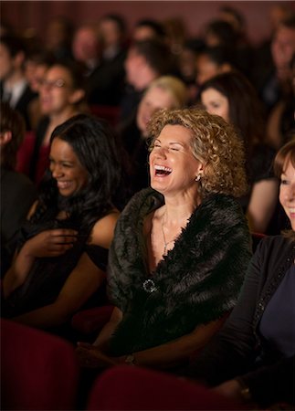 entertainment theatre - Woman laughing enthusiastically in theater audience Stock Photo - Premium Royalty-Free, Code: 6113-07159368