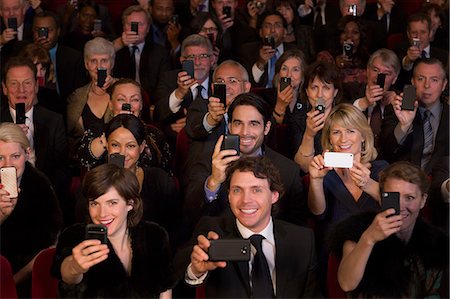 senior hispanic man happy - Theater audience videoing performance with smart phones Stock Photo - Premium Royalty-Free, Code: 6113-07159373