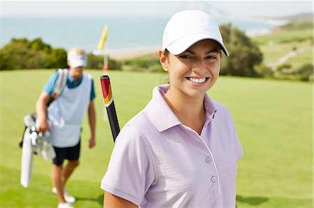 Smiling woman on golf course Photographie de stock - Premium Libres de Droits, Code: 6113-07159323