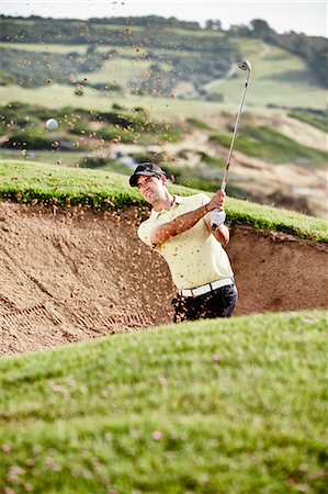 simsearch:6113-07159194,k - Man swinging from sand trap on golf course Stock Photo - Premium Royalty-Free, Code: 6113-07159324