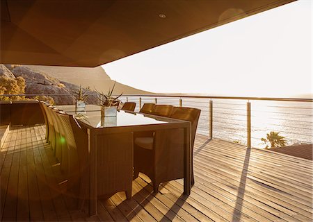 simsearch:6113-07159868,k - Dining table on luxury patio overlooking ocean Foto de stock - Sin royalties Premium, Código: 6113-07159451