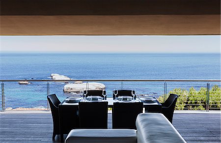 simsearch:6124-08703992,k - Dining table on luxury balcony overlooking ocean Stock Photo - Premium Royalty-Free, Code: 6113-07159465