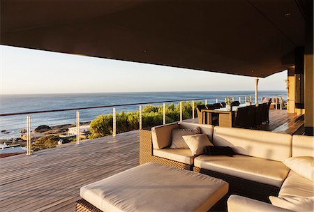 simsearch:6113-07160232,k - Sofa and table on luxury patio overlooking ocean Foto de stock - Sin royalties Premium, Código: 6113-07159478