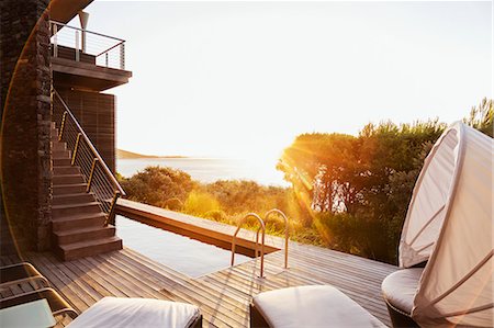 simsearch:6113-07159879,k - Luxury patio overlooking ocean at sunset Stock Photo - Premium Royalty-Free, Code: 6113-07159481