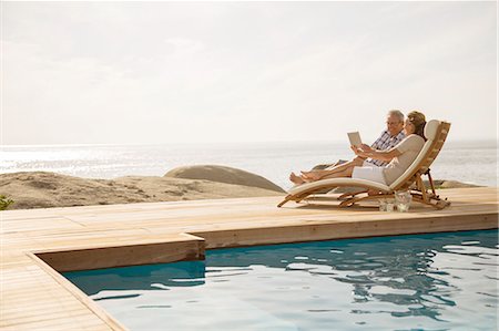 simsearch:6113-07159625,k - Older couple relaxing by pool Stock Photo - Premium Royalty-Free, Code: 6113-07159560