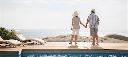 senior citizens pool - Older couple overlooking ocean from balcony Stock Photo - Premium Royalty-Free, Code: 6113-07159587