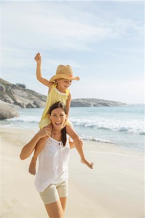 playing - Mother carrying daughter on shoulders on beach Stock Photo - Premium Royalty-Free, Code: 6113-07159589