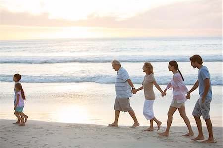 Multi-generation family walking on beach Stock Photo - Premium Royalty-Free, Code: 6113-07159522