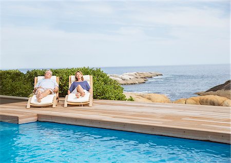 simsearch:6113-07159537,k - Senior couple relaxing at poolside Stock Photo - Premium Royalty-Free, Code: 6113-07159528