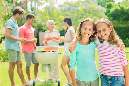 smiling senior people talking family - Girls hugging at backyard barbecue Stock Photo - Premium Royalty-Free, Code: 6113-07159753