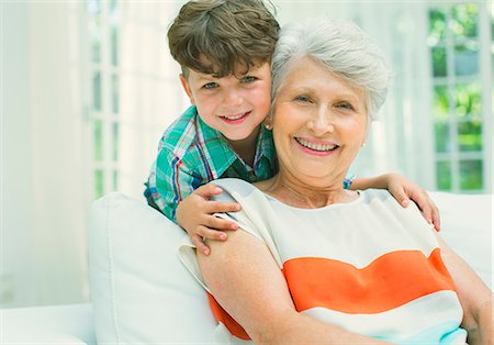 Older woman and grandson smiling in living room Stock Photo - Premium Royalty-Free, Code: 6113-07159750