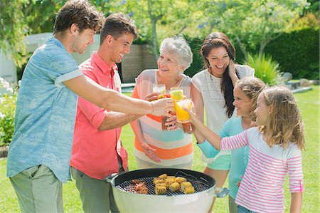 family barbeque outdoors - Family toasting each other at barbecue Photographie de stock - Premium Libres de Droits, Code: 6113-07159751