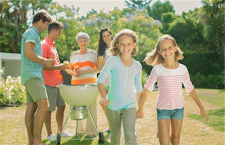 father daughter holding hands - Family relaxing together in backyard Stock Photo - Premium Royalty-Free, Code: 6113-07159704