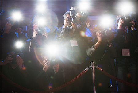 paparazzi camera flash at night - Paparazzi using flash photography at red carpet event Stock Photo - Premium Royalty-Free, Code: 6113-07159888