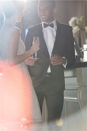 drinking - Well dressed couple talking and drinking champagne and cocktail Stock Photo - Premium Royalty-Free, Code: 6113-07159907