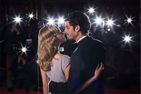 Paparazzi photographing celebrity couple kissing at red carpet event Stock Photo - Premium Royalty-Free, Code: 6113-07159914