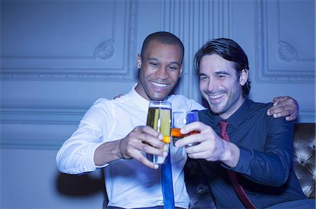 simsearch:649-07063514,k - Well dressed men hugging and toasting beer and cocktail Stock Photo - Premium Royalty-Free, Code: 6113-07159931