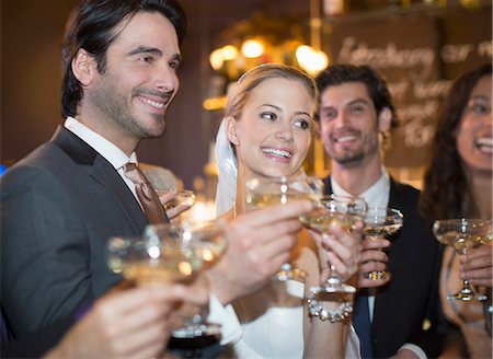 spanish female - Close up of bride and groom toasting champagne glasses Stock Photo - Premium Royalty-Free, Code: 6113-07160068